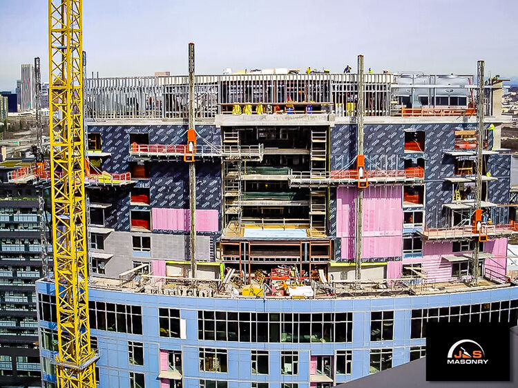 J&S Masonry’s construction site at Mirabella with hydraulic mast climbing scaffold